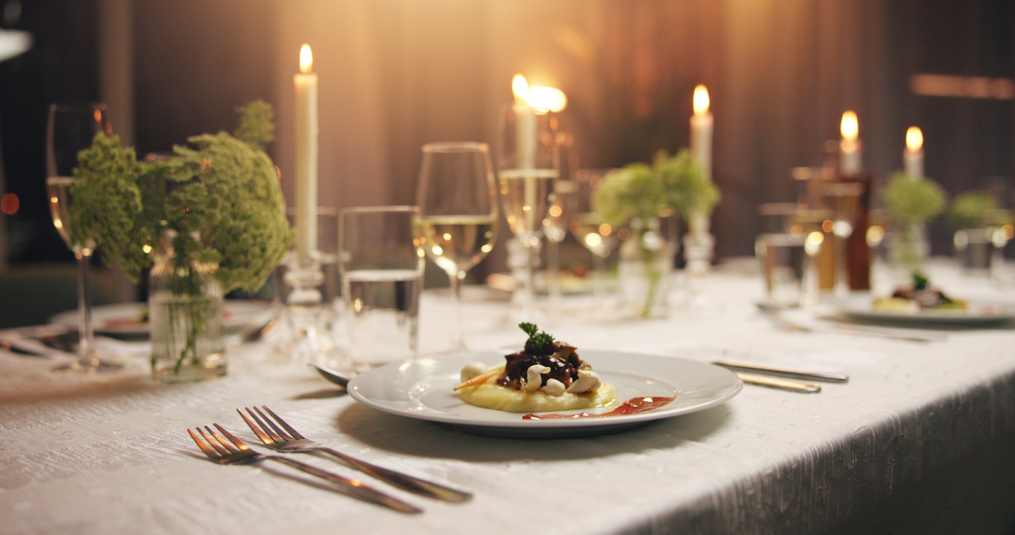 Plate, food and empty dinner table at event with catering, candles and service for gala at night. M