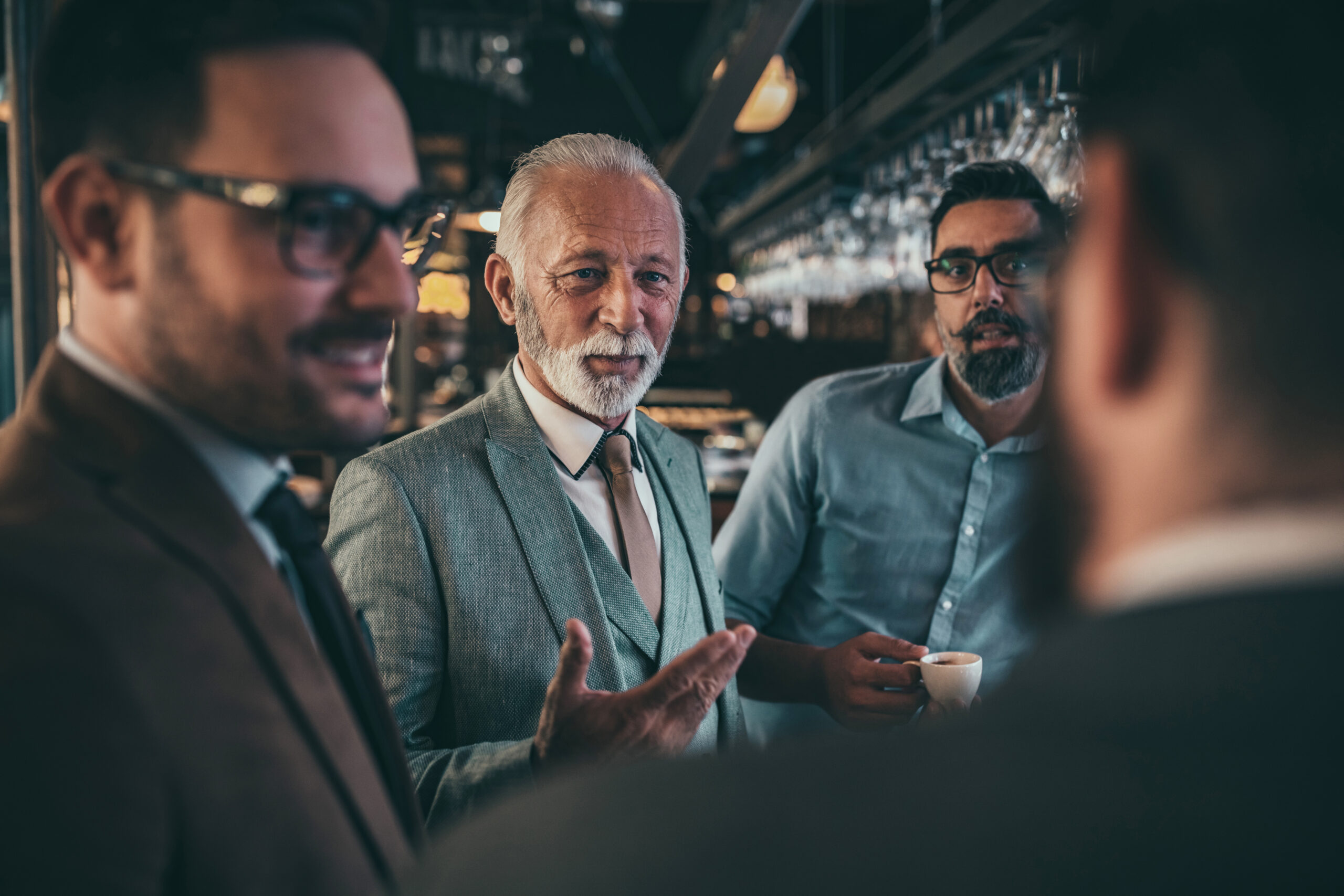 Group of businessmen socializing at the bar