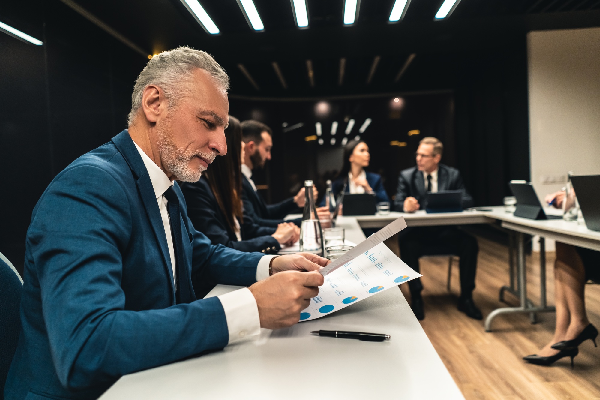 The business people at the meeting.